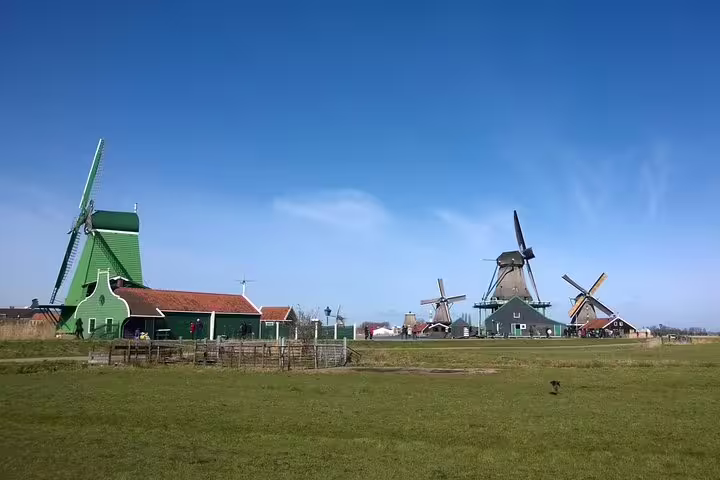 Zaanse Schans windmills and green wooden houses on Dutch countryside private tour from Amsterdam to Volendam