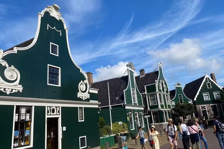 Zaanse Schans green wooden houses and visitors, a popular day trip stop on Netherlands tour from Amsterdam