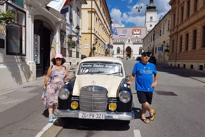Vintage Mercedes and tourists on Zagreb BIG Tour near St Mark’s Church in Upper Town historic street