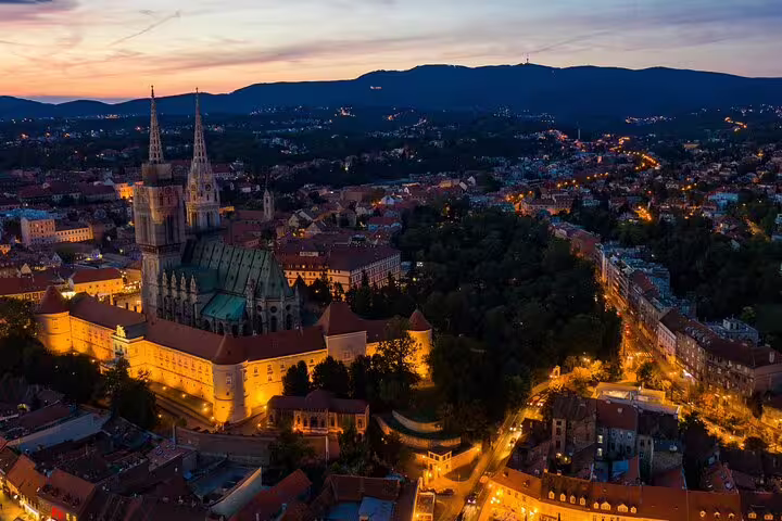 Night aerial of Zagreb Cathedral and city lights, iconic highlight for a Zagreb self-guided scavenger hunt tour