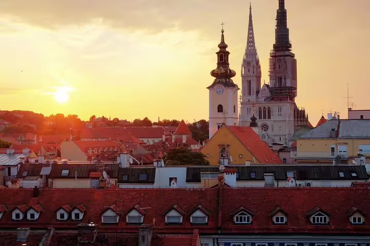 Sunset over Zagreb Cathedral and Upper Town rooftops, scenic clue spot on a self-guided scavenger hunt tour
