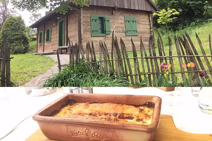 Traditional wooden cottage and baked local lunch dish on the From Zagreb fairytale castle and wine tasting tour
