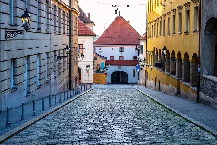 Cobblestone street in Zagreb Upper Town leading to historic gate, perfect for a self-guided scavenger hunt tour