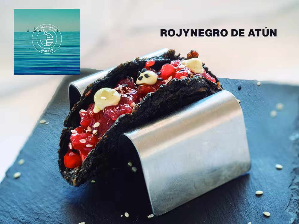 Gourmet tuna taco with vibrant toppings showcased at Zahara Tuna Festival Day Trip on a sleek serving plate.