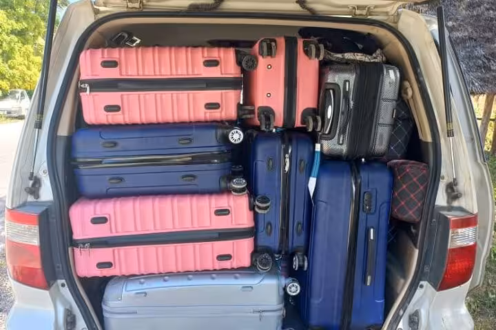 Spacious van loaded with colorful luggage for Zanzibar Airport hotel transfer service.