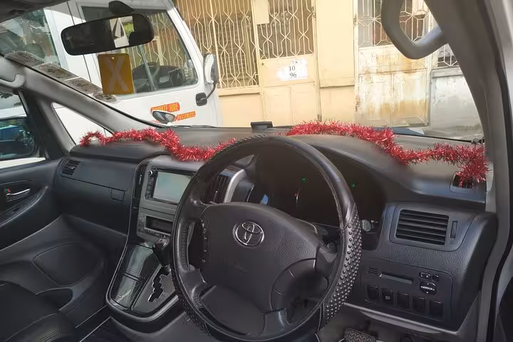 Interior view of clean, modern minivan with GPS, part of 24/7 private airport transfer service to Nungwi hotels, Zanzibar.