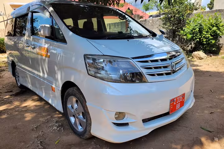 Spacious white van for private airport transfers to Nungwi hotels in Zanzibar, offering 24/7 service for travelers.