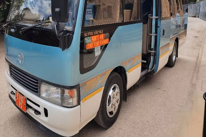 Close-up of blue transfer minibus highlighting comfort for Zanzibar airport round trip.