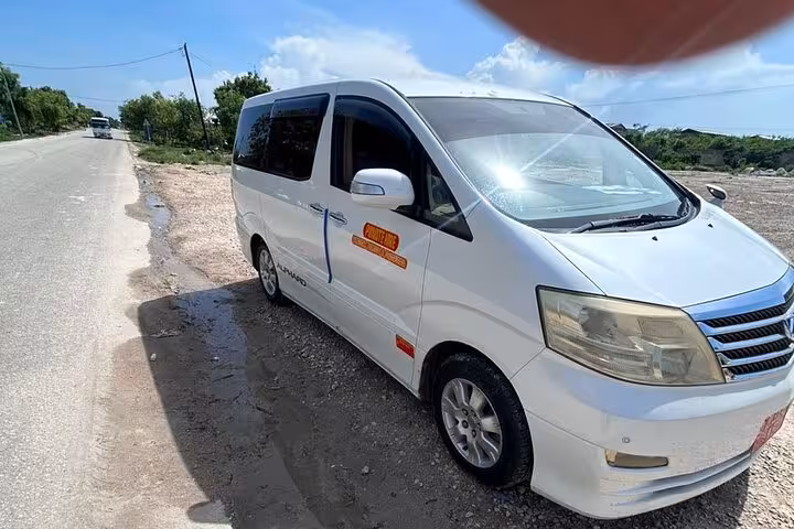 Comfortable private van for Zanzibar airport transfer to East Coast hotels on a sunny day.