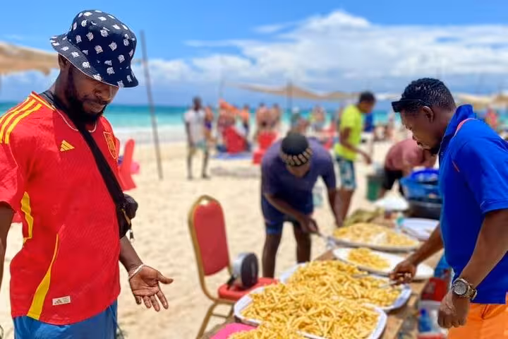 Beach vendors serving delicious local snacks to visitors on Zanzibar Island, offering a taste of authentic cuisine.