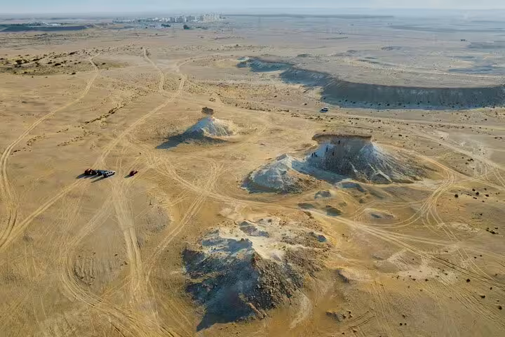 Aerial view of Zekreet's Mushroom Rock Formation with desert landscape, highlighting the unique geology of West Coast tours.