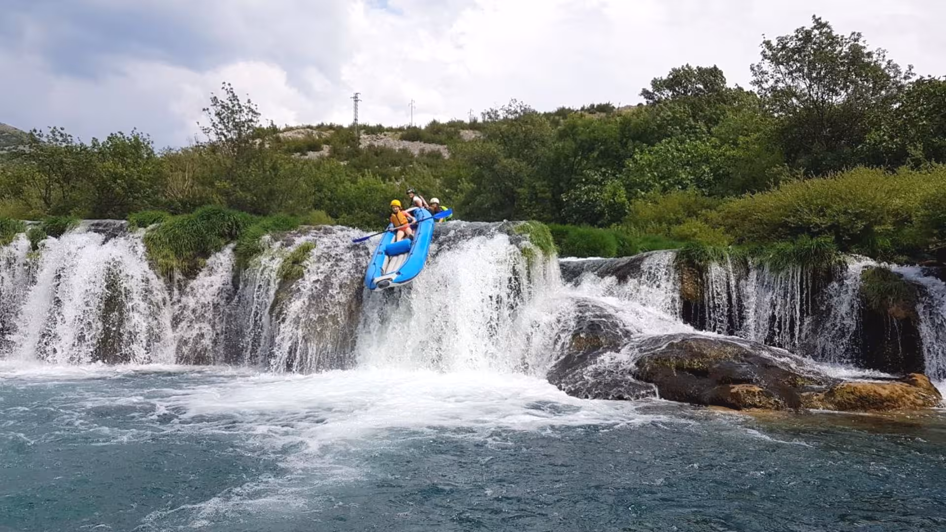 A person in a kayak jumping off a 3 m waterfall