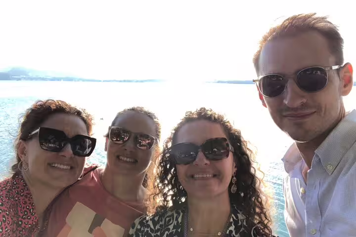 Group selfie at Lake Zug on a self-guided Zug scavenger hunt tour, enjoying sunny lakeside sightseeing