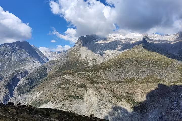 Swiss Alps panorama on Zurich day trip to Aletsch Glacier, with rugged peaks and summer clouds