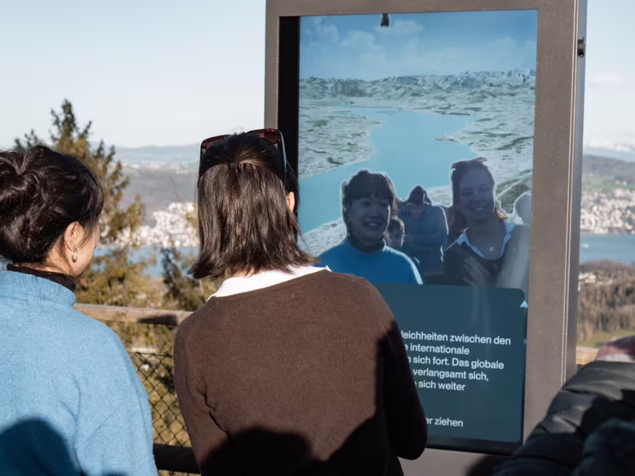 Tourists enjoy scenic Zurich views with an interactive display during a half-day cable car tour.