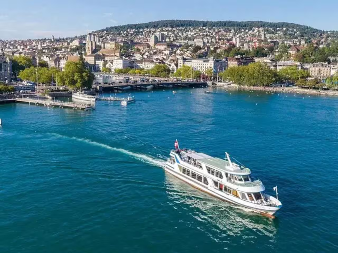 Cruise boat on Lake Zurich with panoramic city views, ideal for exploring Zurich on a private tour with a chocolate visit.