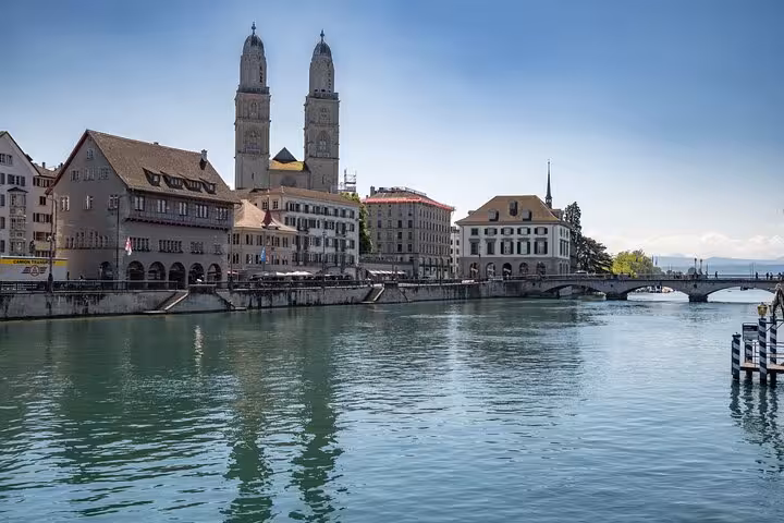 Limmat River view of Grossmünster towers and bridges, highlight of Zurich 360 city walk hidden spots