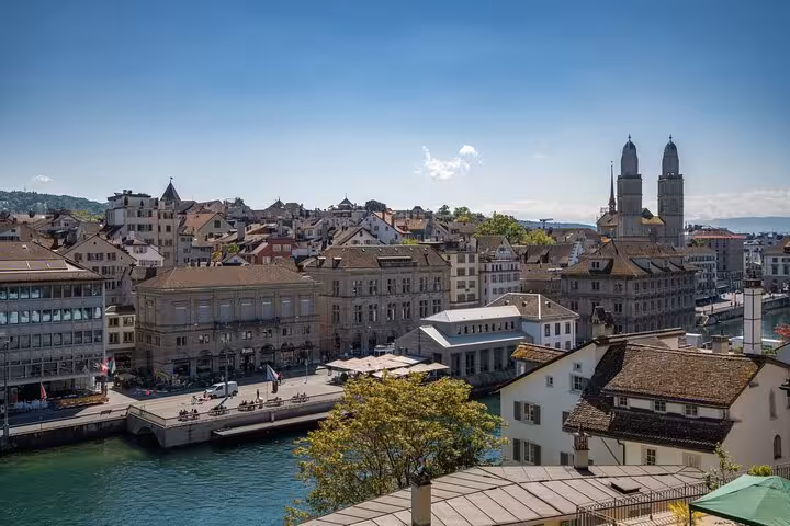 Zurich Limmat riverfront with Grossmünster towers in view, iconic panorama on the Zurich 360 city walk tour