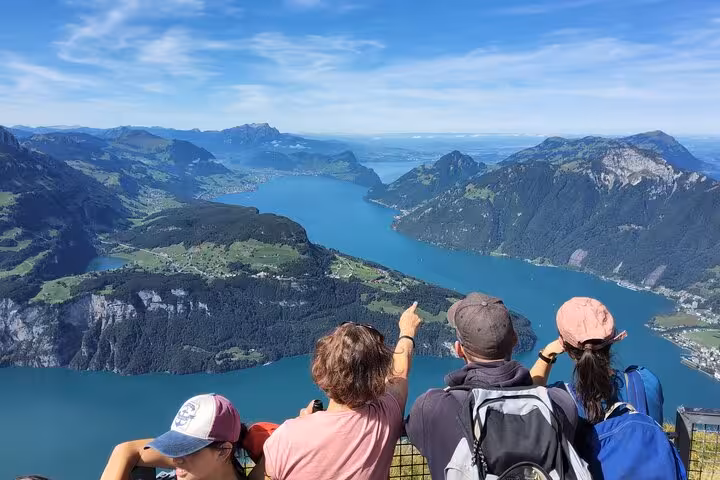 Hikers admire sweeping Lake Lucerne views from Mount Rigi on a Zurich day trip with steep funicular ride