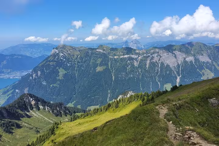 Scenic trail to Rophaien panoramic peak above Lake Lucerne on Zurich day trip, sweeping Swiss Alps views