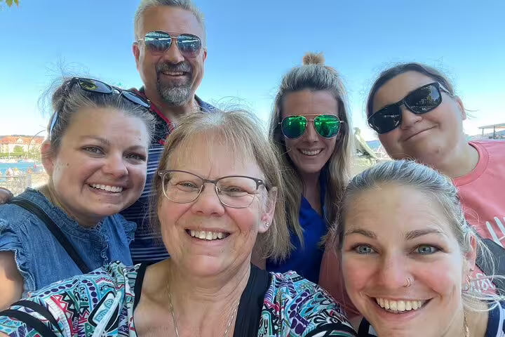 Group selfie on Zurich waterfront while exploring landmarks on a self-guided scavenger hunt city tour