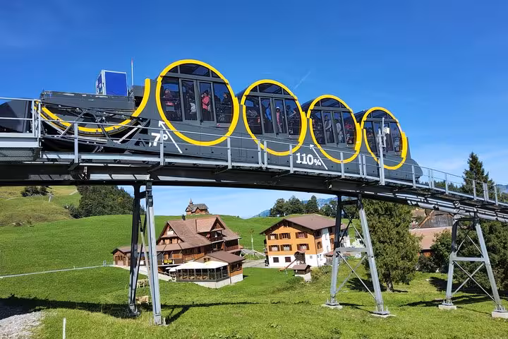 World’s steepest funicular at Stoos on tracks above green meadows, a must-do Zurich day trip to Mount Rigi