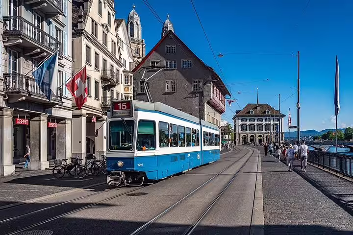 Blue tram passing through Zurich's historic streets, offering scenic views on the way to the Lake of Zurich.
