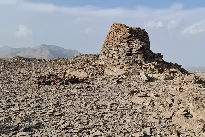 Explore ancient stone structures amidst rugged terrain on a 3-day private tour in Oman with convenient pick-up.