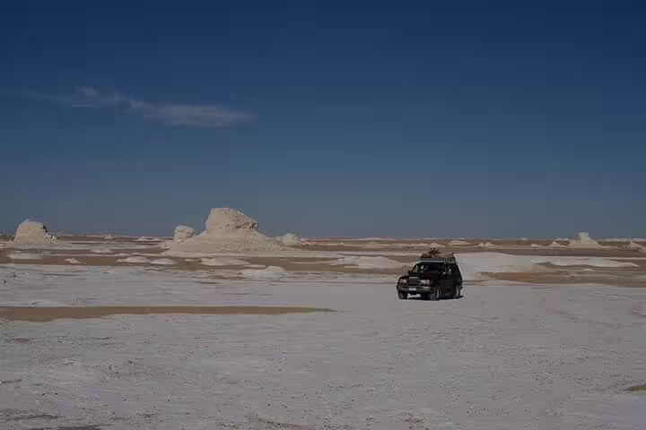 4x4 desert safari crossing Egypt’s White Desert on overnight camping trip from Bahariya Oasis, vast chalk plains