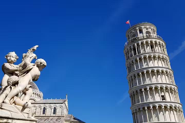 Iconic Leaning Tower of Pisa with cherub statue under blue sky on self-guided mystery puzzle walking tour
