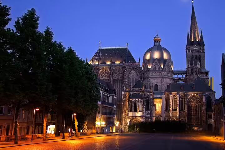 Aachen Cathedral lit at dusk, key stop on Aachen scavenger hunt and highlights self-guided walking tour