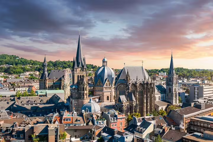 Panoramic Aachen skyline at sunset with Aachen Cathedral, perfect for a self-guided scavenger hunt highlights tour