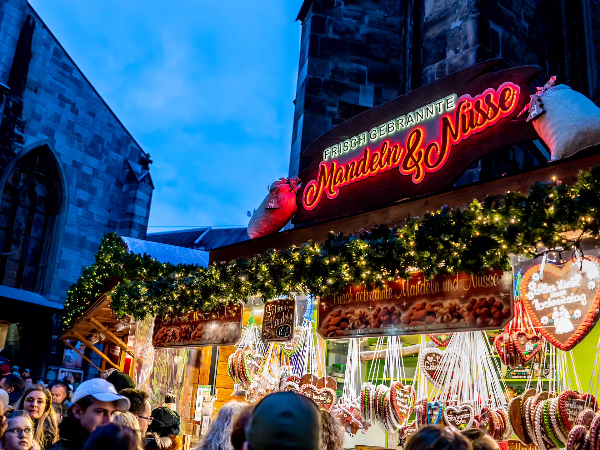 Aachen Christmas market stall by the cathedral, roasted almonds and gingerbread on a 1-day audioguide walk
