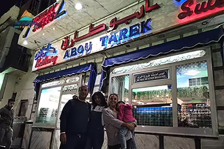 Guests pose outside Abou Tarek in Downtown Cairo, a classic stop on the half-day tour with Egyptian dinner