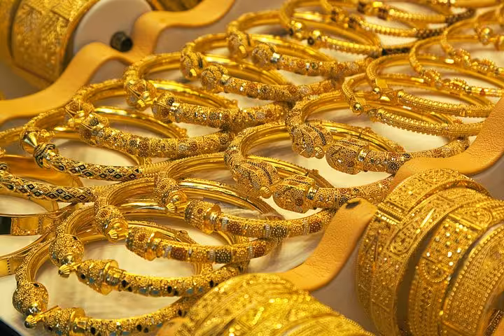 Discover Abu Dhabi's opulent gold souk featuring intricate bracelets and bangles, a highlight of luxury shopping.
