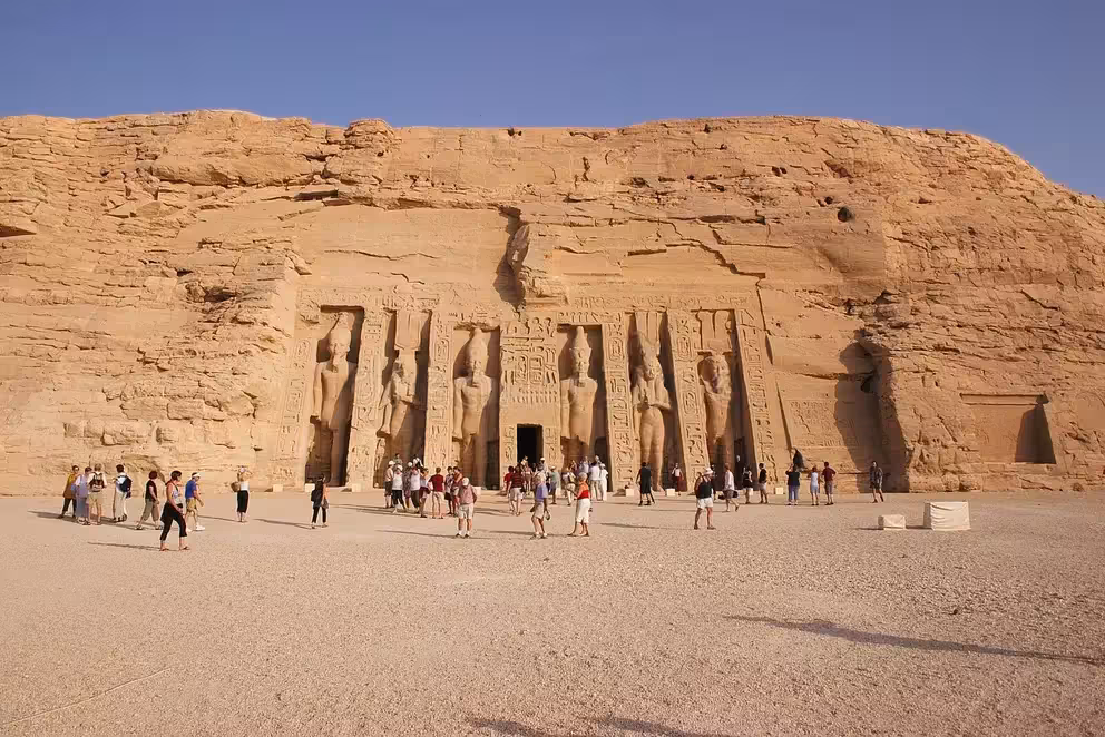 Tourists at Abu Simbel Great Temple facade on early morning day trip from Aswan with guide or transport