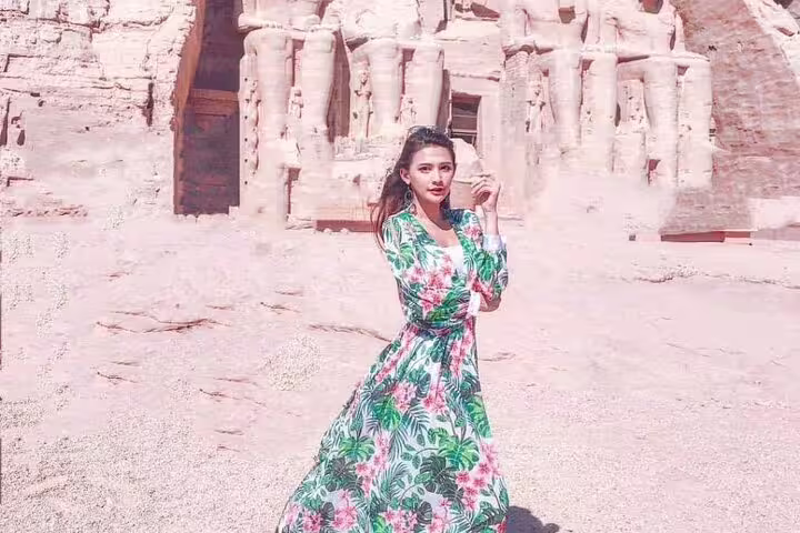 Traveler posing outside Abu Simbel temples in Nubian desert, Abu Simbel day tour from Aswan, Egypt