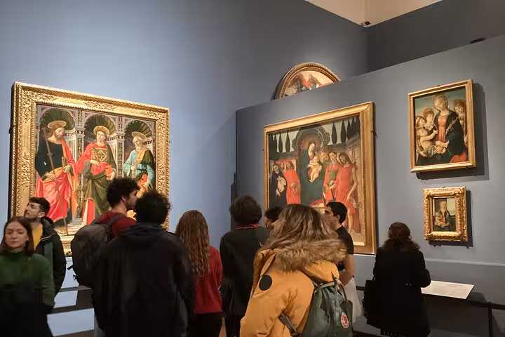 Tour group exploring Renaissance art at the Uffizi Gallery, part of the Accademia and Uffizi Small-group Tour.