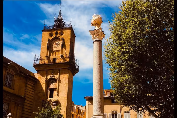 Aix-en-Provence clock tower and fountain column on walking wine tour linking Cézanne heritage and vineyards
