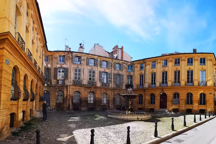 Historic Aix-en-Provence courtyard with fountain and ochre facades, highlight of full-day shore excursion tour