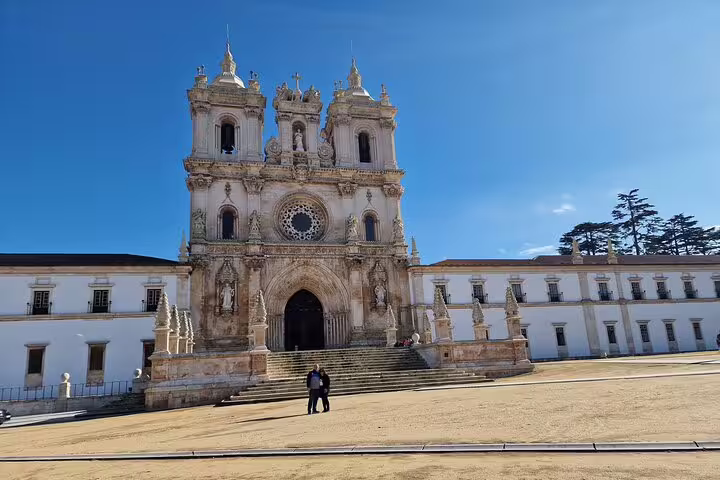 Stunning view of Alcobaça Monastery, a UNESCO World Heritage Site, showcasing Gothic architecture on a sunny day in Portugal.