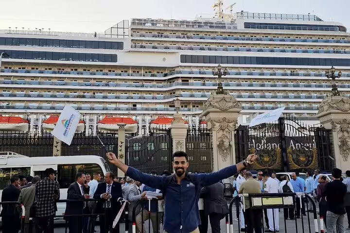 Guest waving flags outside Alexandria Port cruise terminal before private Giza Pyramids and Cairo Museum tour