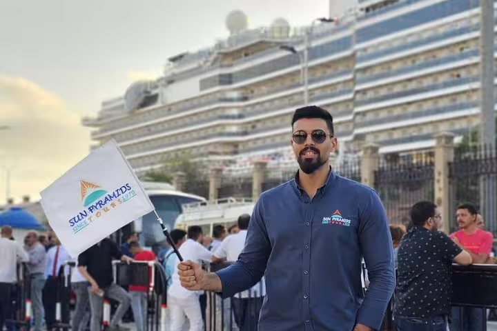 Tour guide welcomes guests at Alexandria cruise port for Giza Pyramids day trip with Nile cruise and lunch