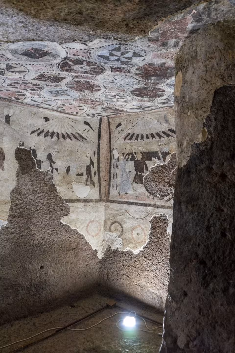 Explore ancient frescoes in Alghero's archaeological sites with intricate designs on the walls and ceilings.