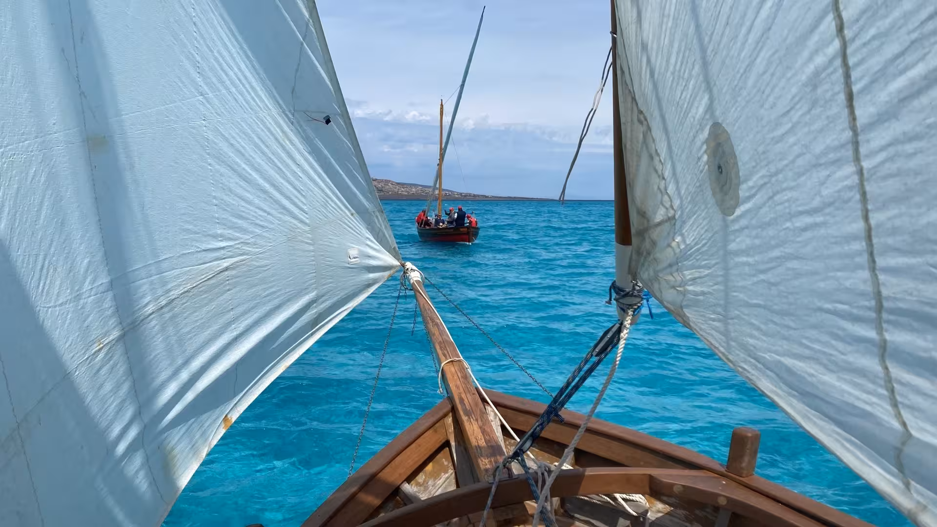 Experience Alghero's turquoise waters from the deck of a traditional sailing boat on a guided tour.