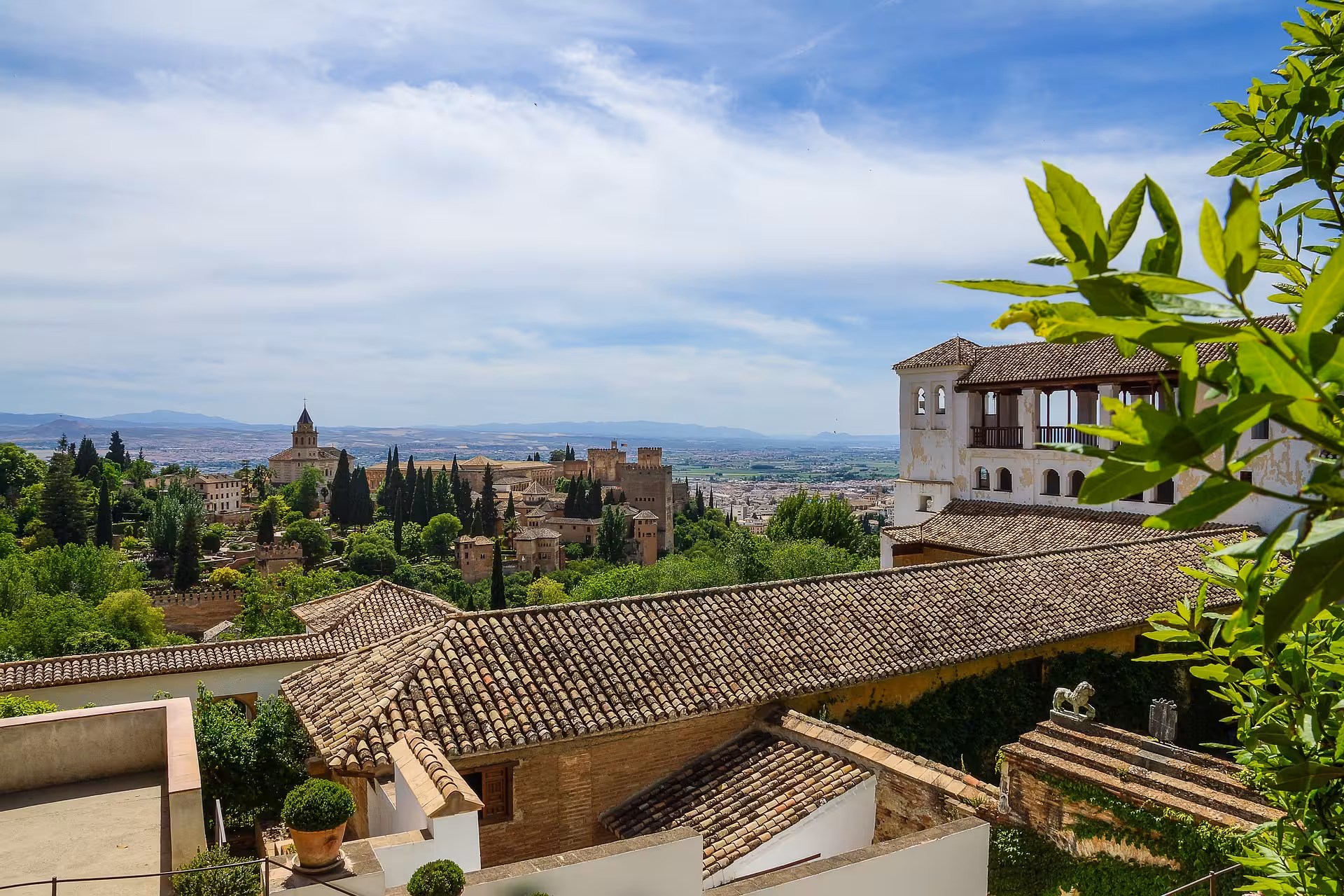 Panoramic view of the Alhambra and surrounding landscape from a vantage point in Granada, Spain.