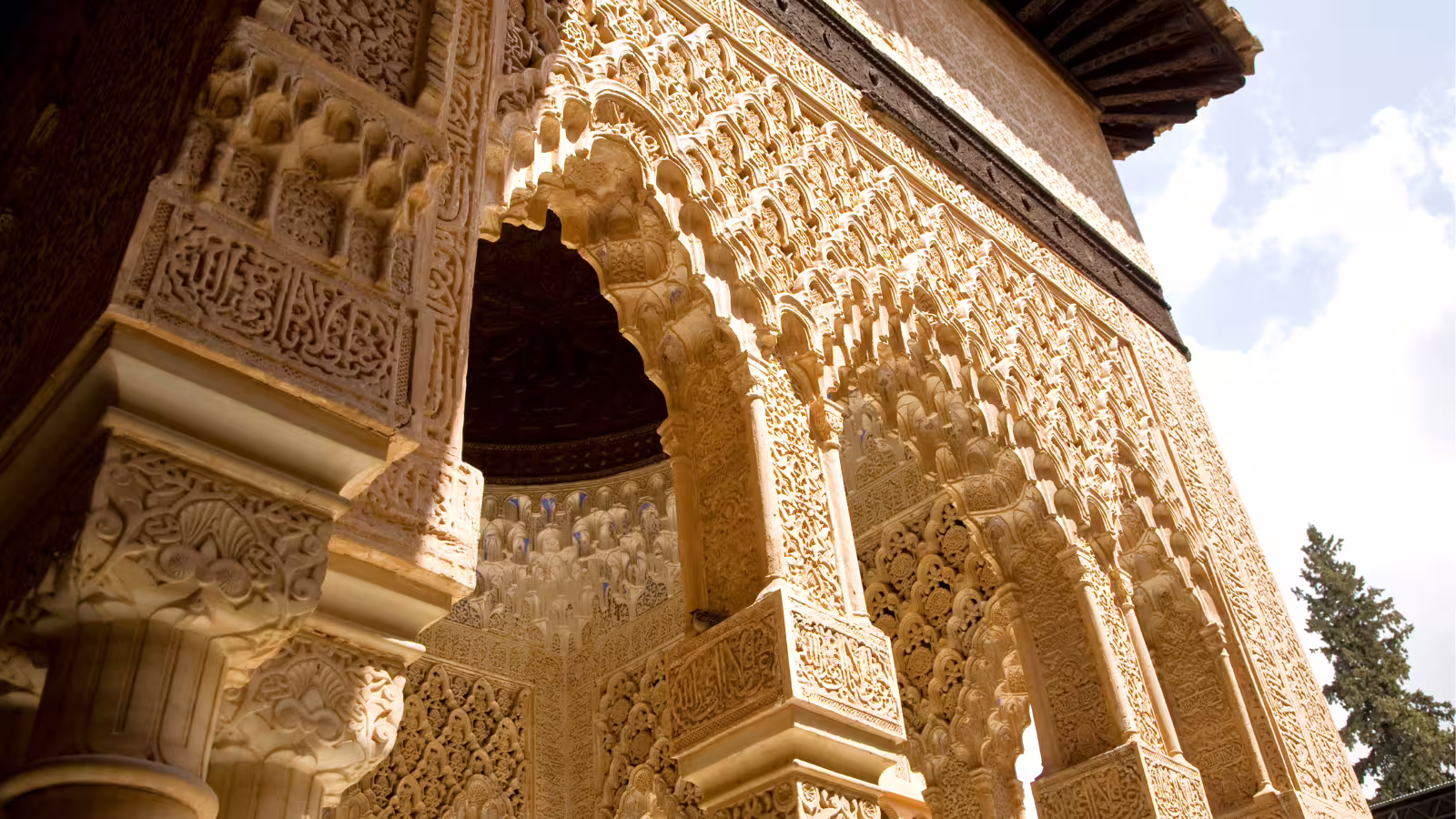 Intricate Moorish arch and carvings inside the Alhambra Palace, Granada, on a private guided tour with hotel pick-up