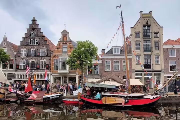 Historic canal boats and gabled houses in Alkmaar, Netherlands, on an Explore Highlights GPS audio tour