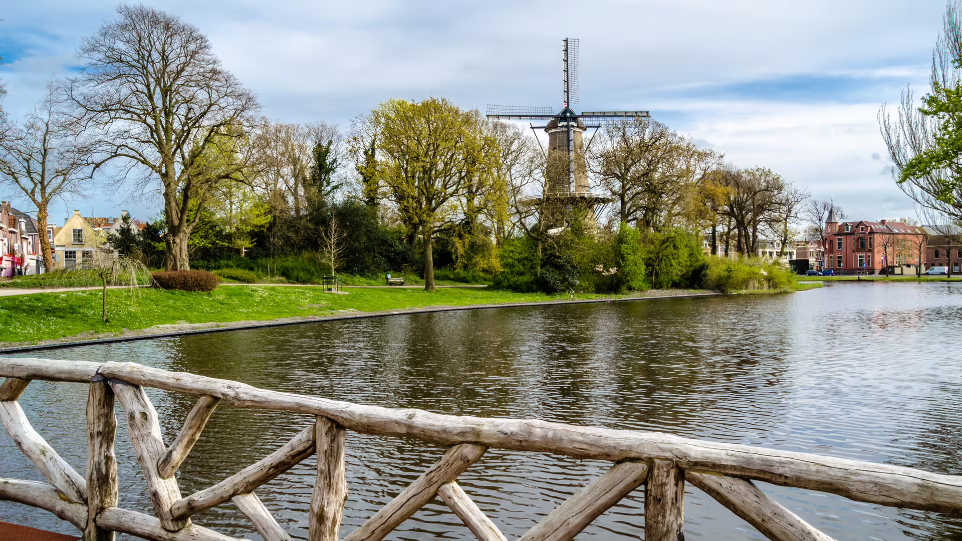 Windmill by the canal in Alkmaar, Netherlands, scenic stop on a 1-day walking tour with multilingual audioguide