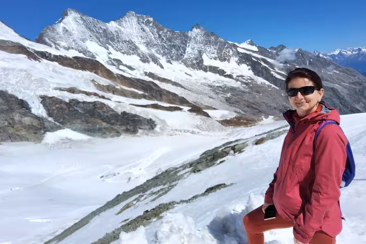 Traveler on snowy Allalin glacier viewpoint near Saas-Fee on Zurich day trip to the highest revolving restaurant
